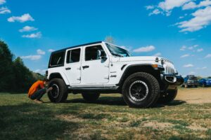 A man having an issue with white jeep vehicle