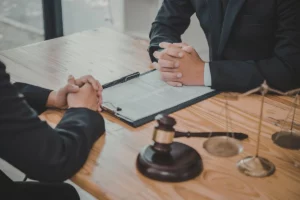 Man consulting lawyer about Song-Beverly warranty act